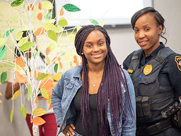 Young woman standing with a police officer