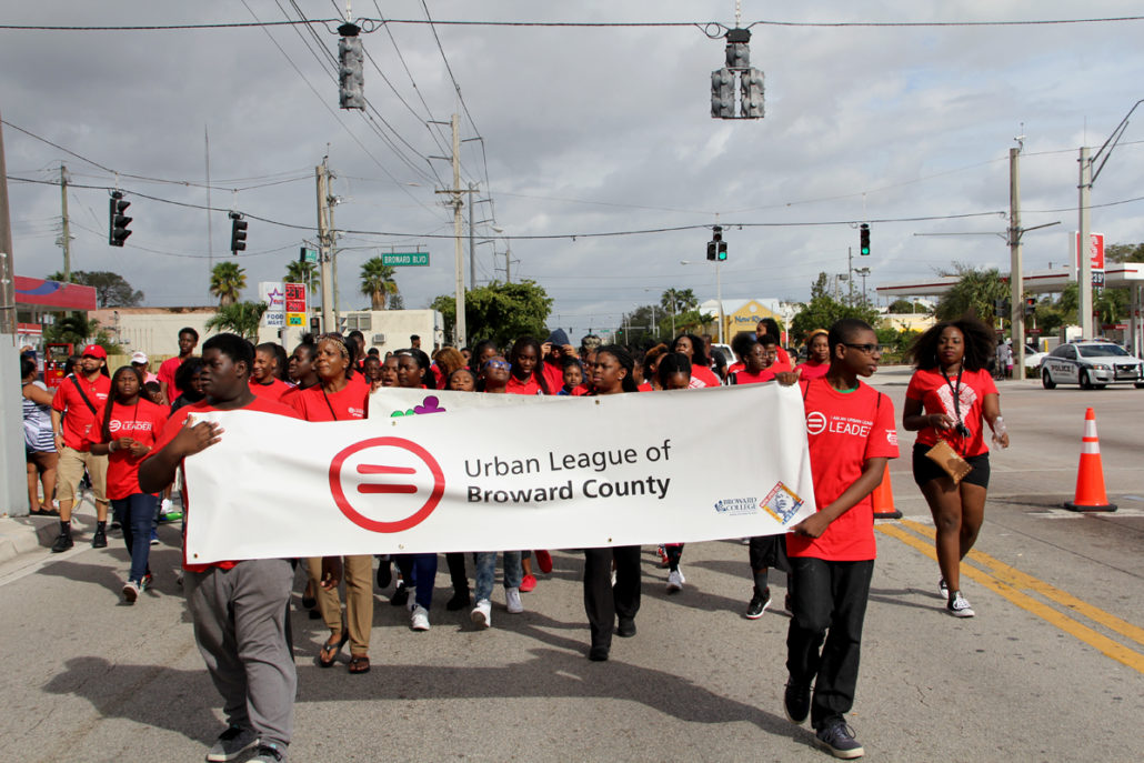 Group of YPN Members walking together holding a sign for the Urban League of Broward County