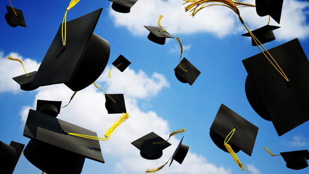 Graduation caps thrown up in the air 