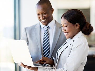 Community leaders reviewing plans on a computer